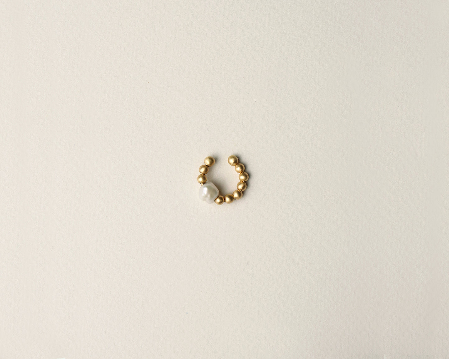 18KT yellow gold earring ear cuff with pearlworn by a female ear - Pearl B