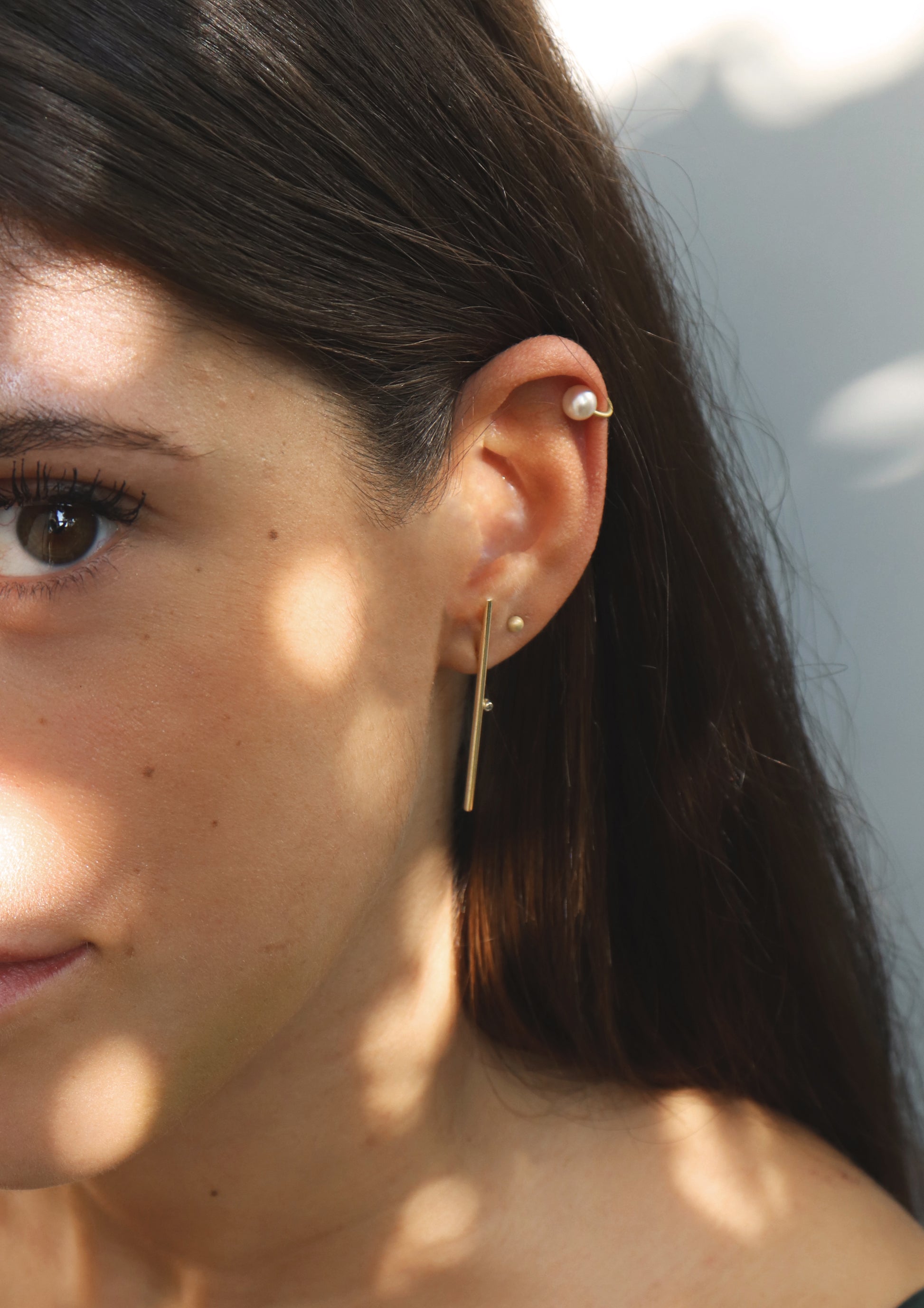 18KT yellow gold earring with diamond worn by a female ear - Linea LD