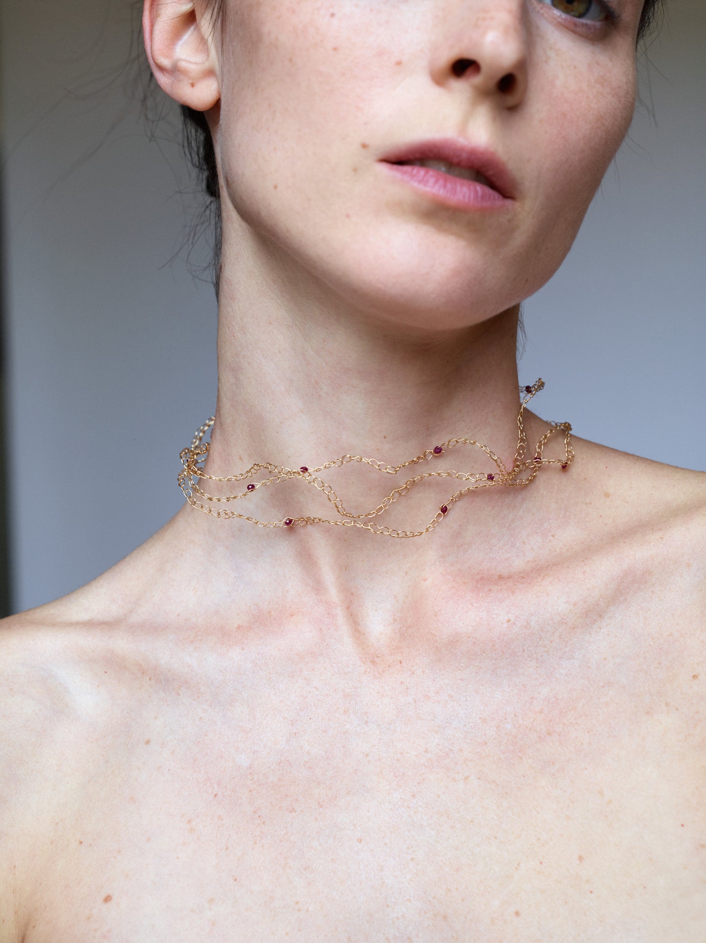 18KT Yellow Gold necklace with rubies worn by a female neck– Medusa