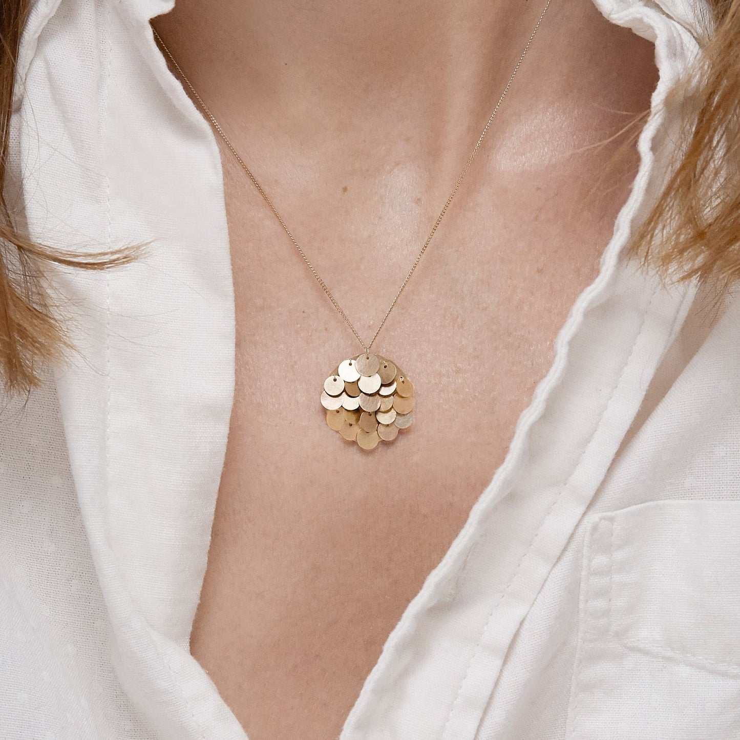 18KT yellow gold pendant necklace worn by a female neck  - Tau 2