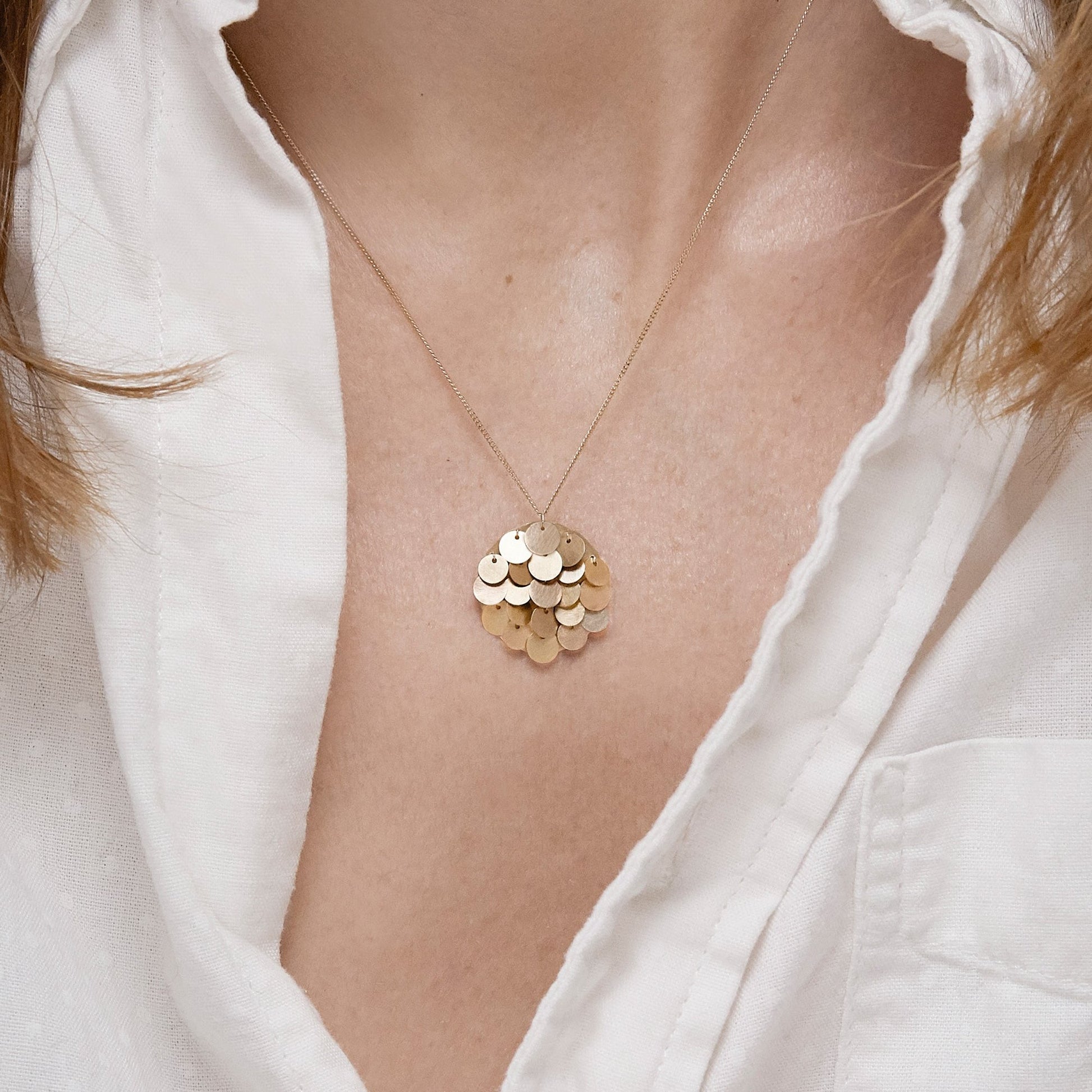 18KT yellow gold pendant necklace worn by a female neck  - Tau 2