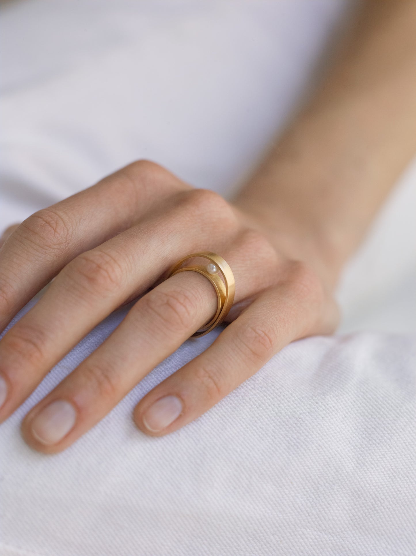 18KT yellow gold bands ring with freshwater pearls worn by a female hand - Other