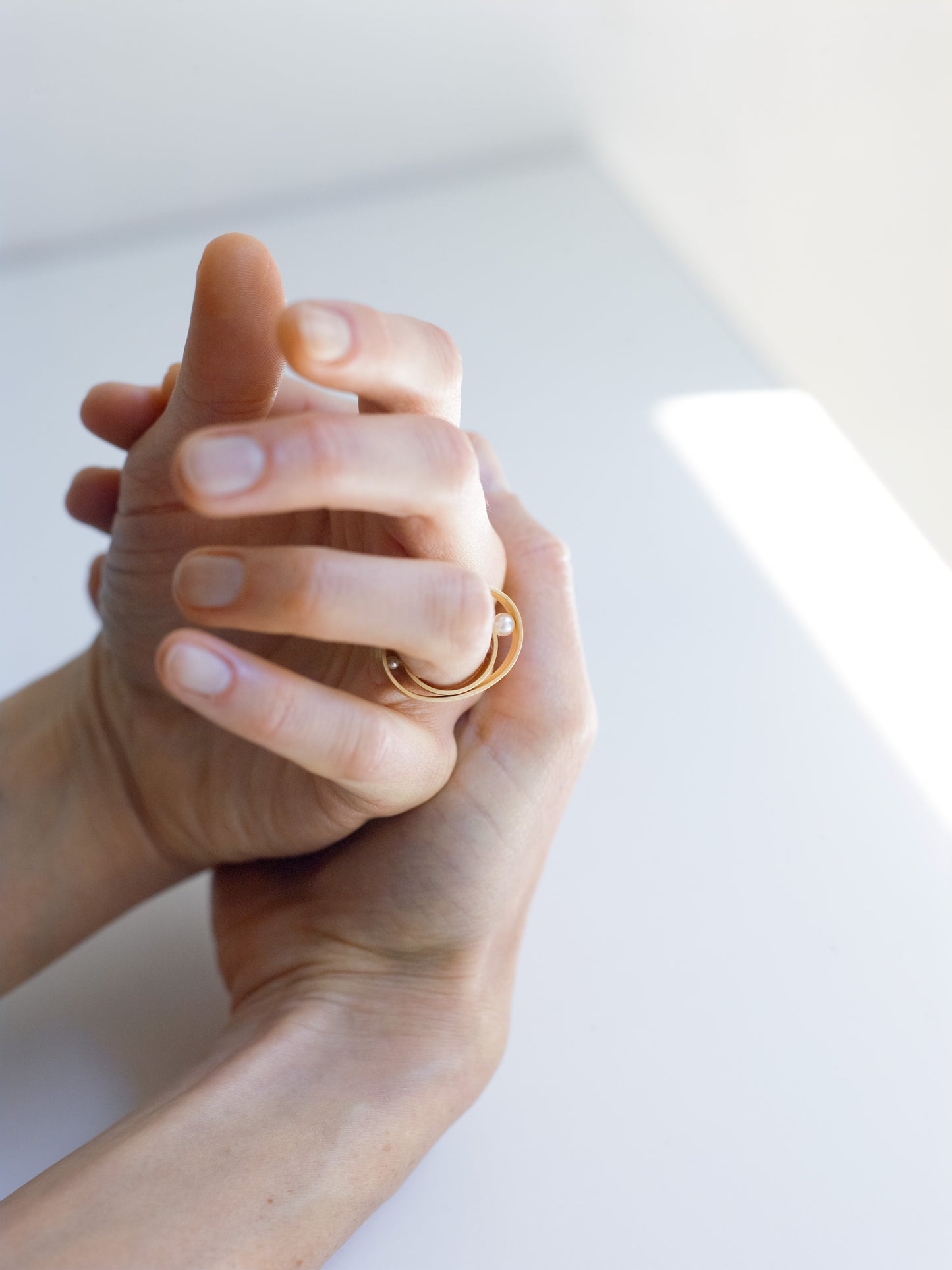18KT yellow gold bands ring with freshwater pearls worn by a female hand - Other