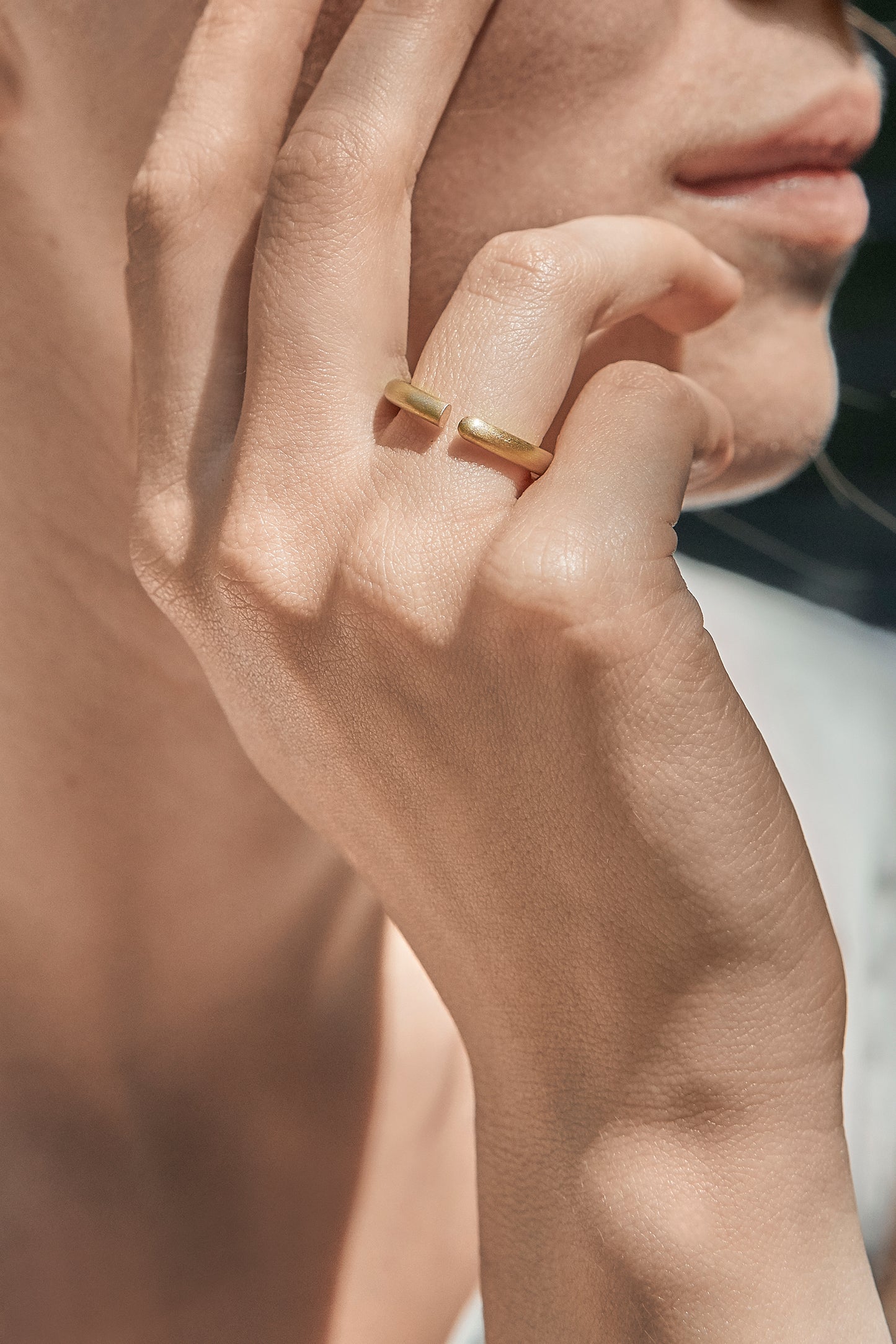 18KT white and yellow gold wedding rings worn by a female hand – Round