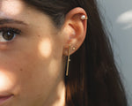 18KT yellow gold earring with diamond worn by a female ear - Linea LD